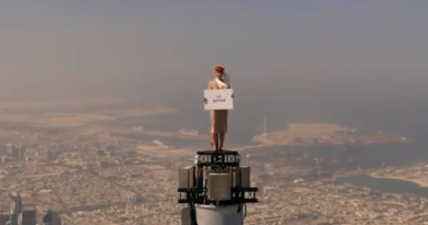 A Woman stands on top of Burj Khalifa